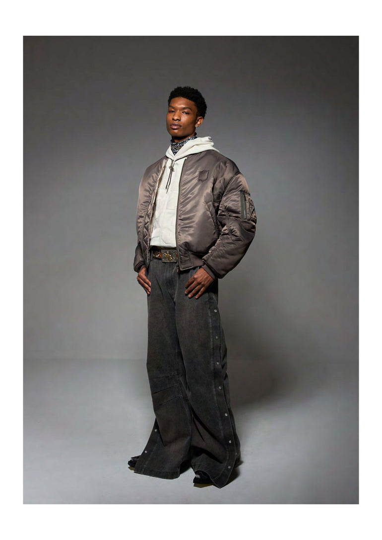 IH NOM UH NIT khaki bomber jacket with tonal logo patch front view.