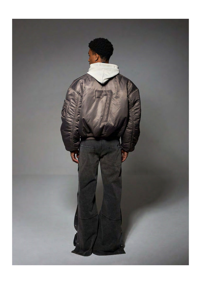 IH NOM UH NIT khaki bomber jacket with embroidered 7 patch back view.