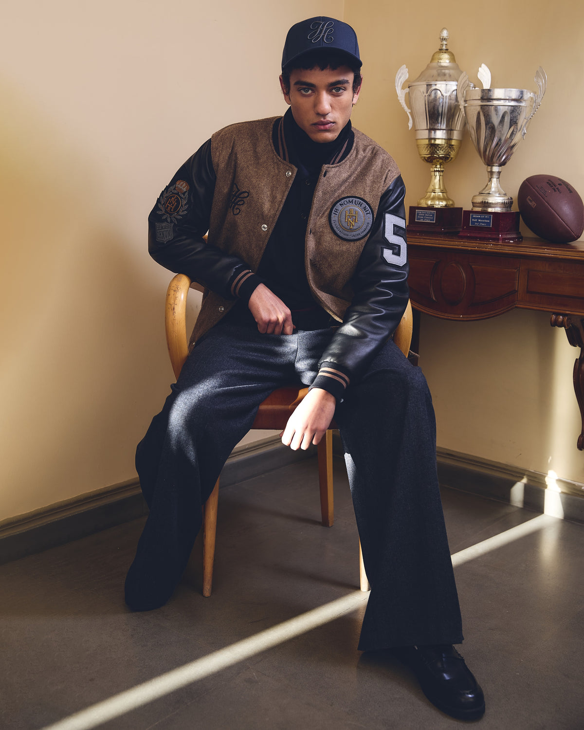 IH NOM UH NIT FW26 black Patch Varsity Jacket with leather sleeves, embroidered patches and number appliqué, front view