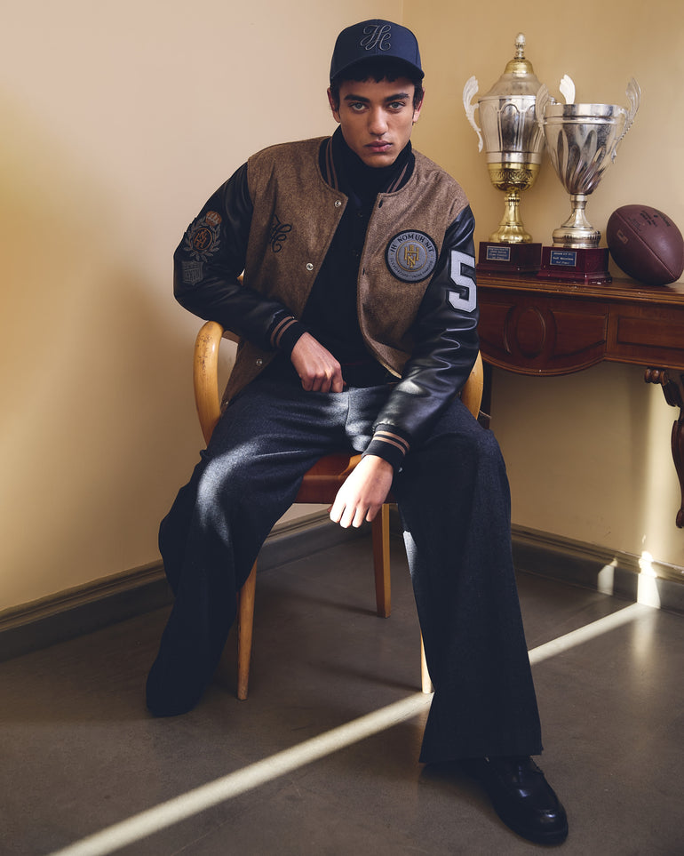 IH NOM UH NIT FW26 black Patch Varsity Jacket with leather sleeves, embroidered patches and number appliqué, front view