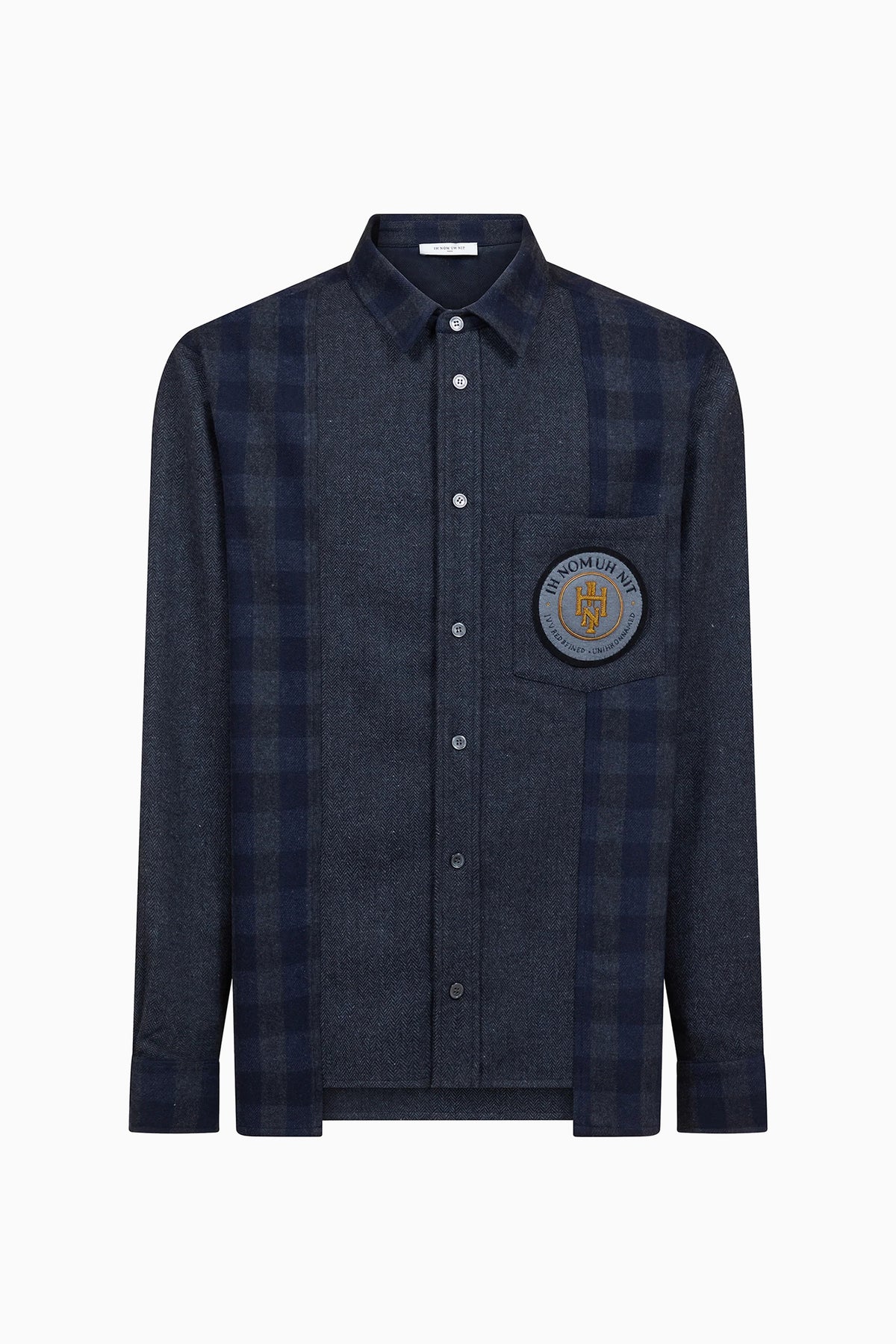 IH NOM UH NIT FW26 dark navy flannel shirt with check panels and embroidered chest patch, front view