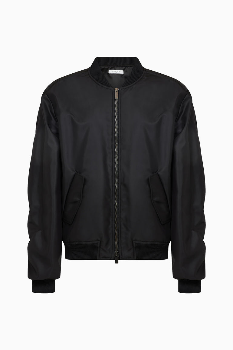 IH NOM UH NIT FW26 oversized black nylon bomber jacket with two-way zip and angled pockets, front view